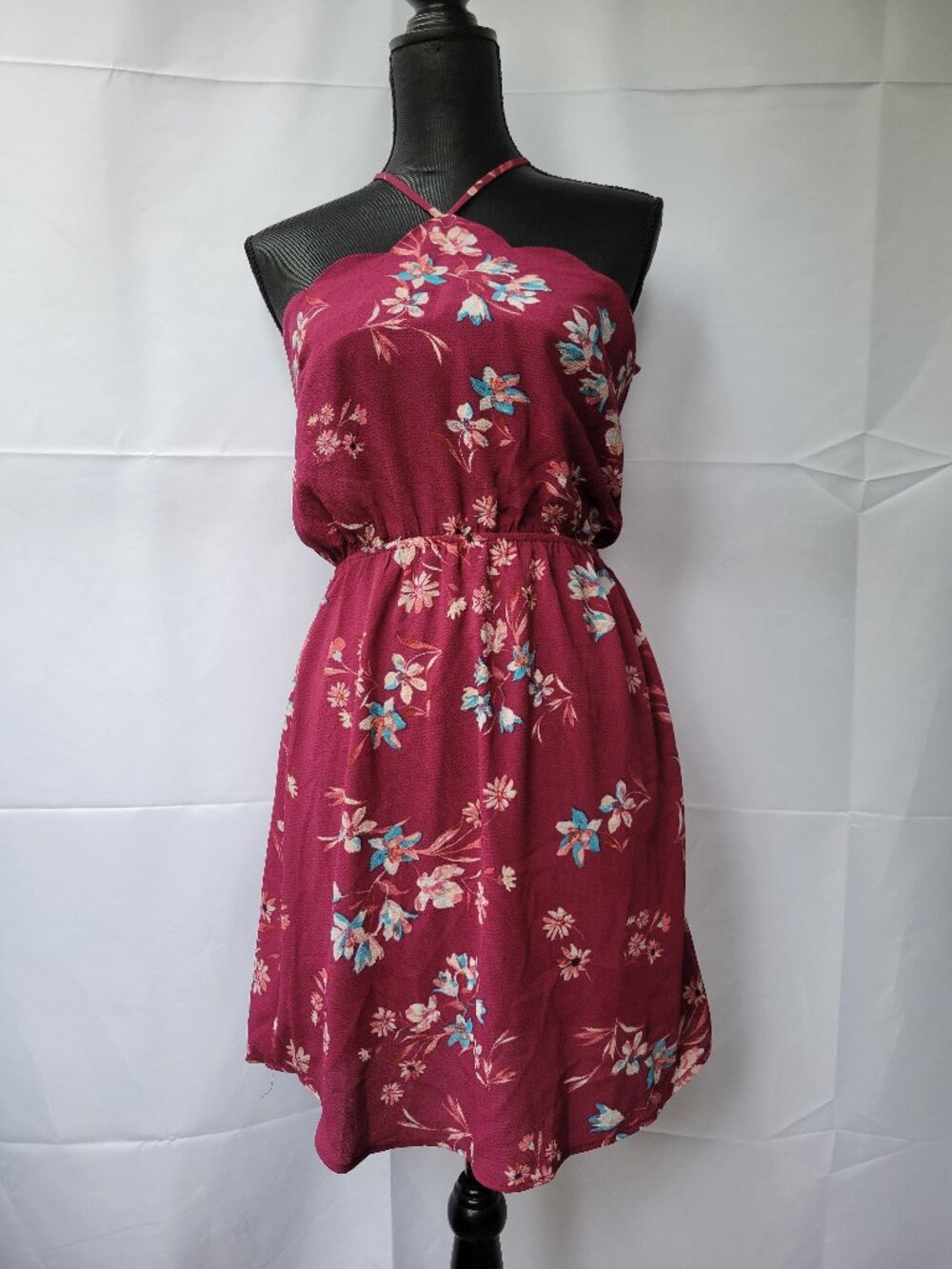 Adorable little sundress in a gorgeous burgundy floral print. Size medium.